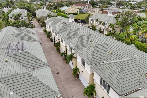 a view of a street with potted plants