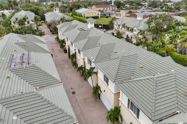 a view of a street with potted plants