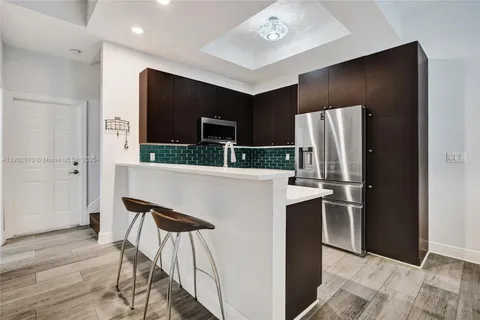 a kitchen with stainless steel appliances a refrigerator and a microwave