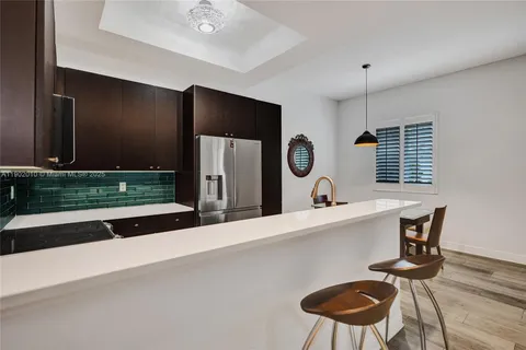 a view of a kitchen with a sink and a fireplace