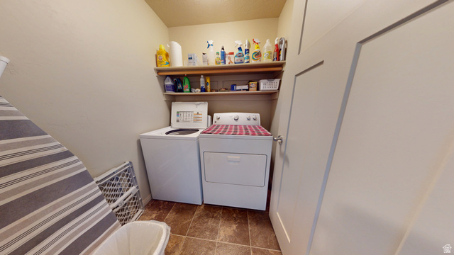 1674 Eastridge Road Price, UT 84501 - Photo 21 of 34 Dedicated laundry area featuring a top-load washing machine, front-load dryer, and built-in shelving