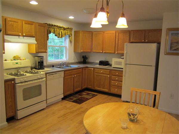 111 Beach Road, Unit 24 Salisbury, MA 01952 - Photo 3 of 13 a kitchen with a sink appliances and cabinets