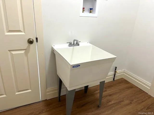 a white room with wooden floor and white walls