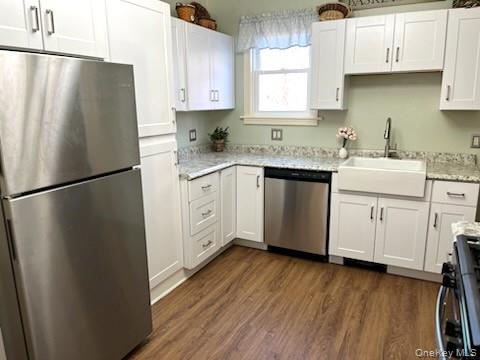 49 Main Street Sparrowbush, NY 12780 - Photo 7 of 21 a kitchen with stainless steel appliances granite countertop a refrigerator sink and white cabinets with wooden floor