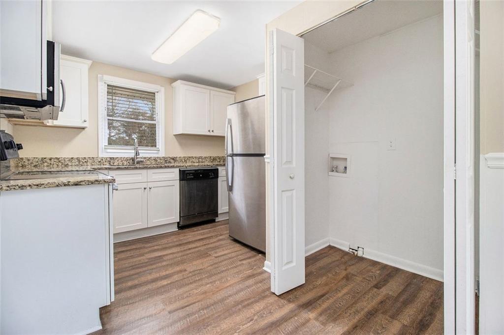 3409 Glensford Drive Decatur, GA 30032 - Photo 4 of 15 a kitchen with wooden floors and white appliances