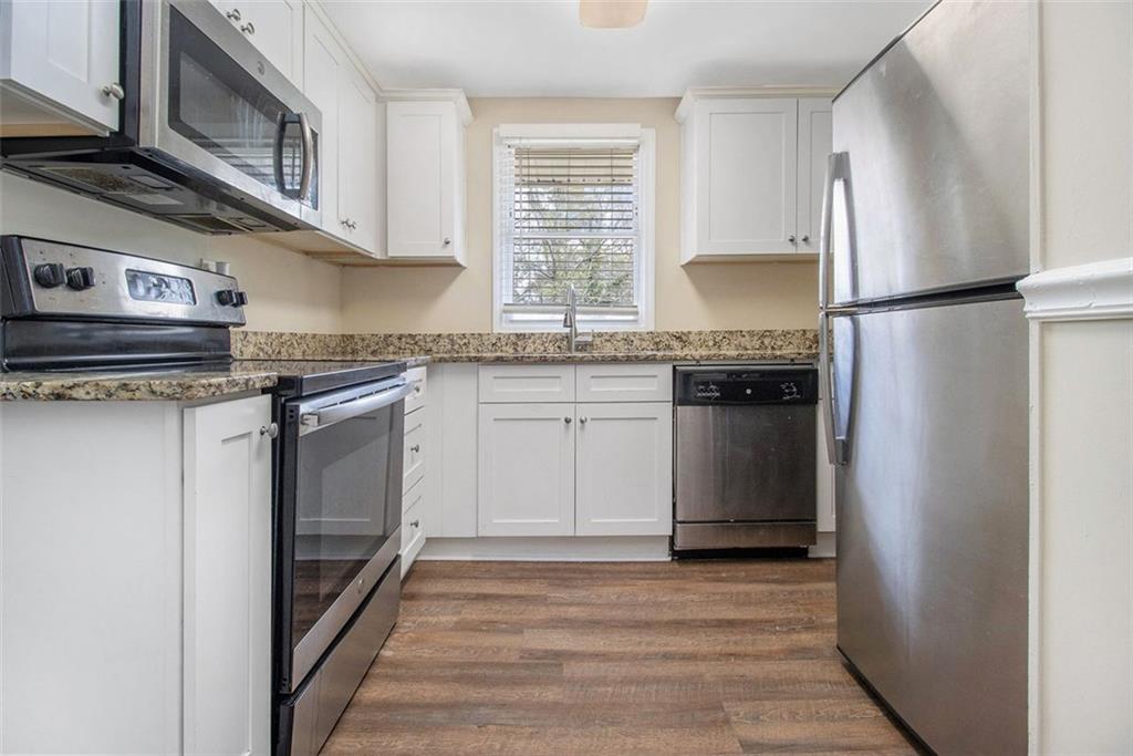 3409 Glensford Drive Decatur, GA 30032 - Photo 5 of 15 a kitchen with stainless steel appliances granite countertop a stove a refrigerator and a microwave