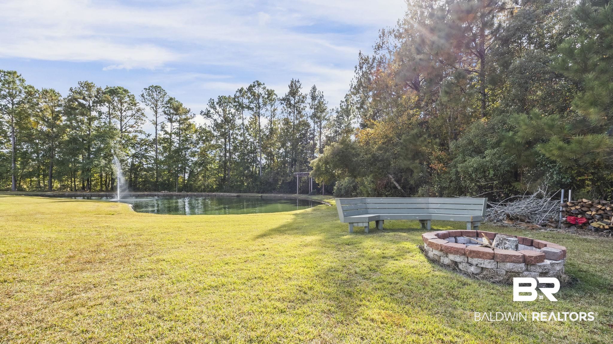12004 Raptor Court Elberta, AL 36530 - Photo 28 of 57 View of green lawn featuring a water view and a fire pit
