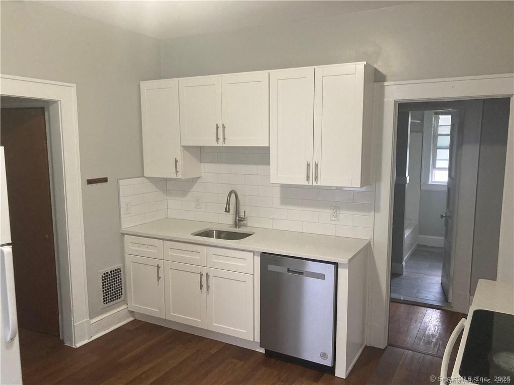 193-195 Wolcott Hill Road Wethersfield, CT 06109 - Photo 18 of 29 a kitchen with stainless steel appliances granite countertop a sink and cabinets