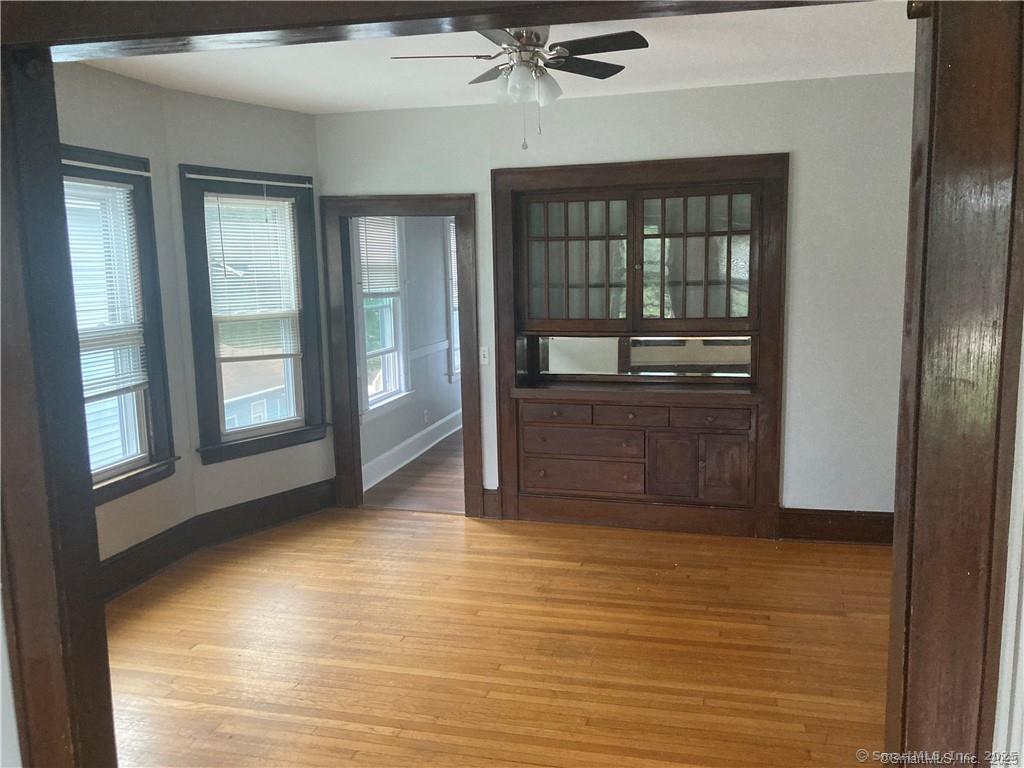 193-195 Wolcott Hill Road Wethersfield, CT 06109 - Photo 20 of 29 a view of a hallway with wooden floor and chandelier