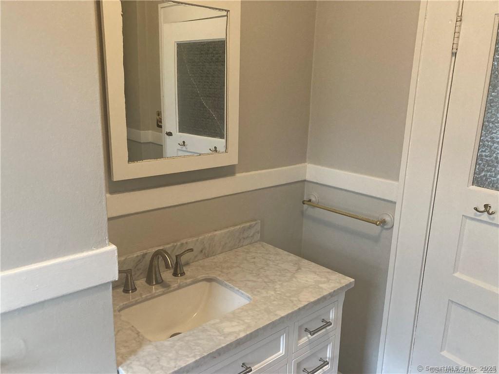 193-195 Wolcott Hill Road Wethersfield, CT 06109 - Photo 22 of 29 a bathroom with a granite countertop sink and a mirror