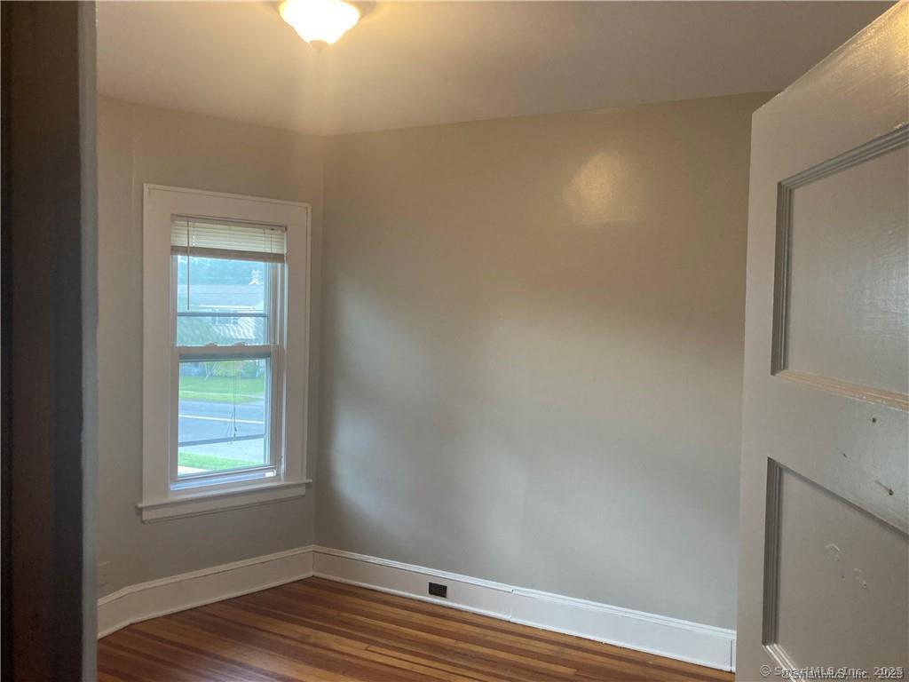 193-195 Wolcott Hill Road Wethersfield, CT 06109 - Photo 24 of 29 a view of room with window and wooden floor
