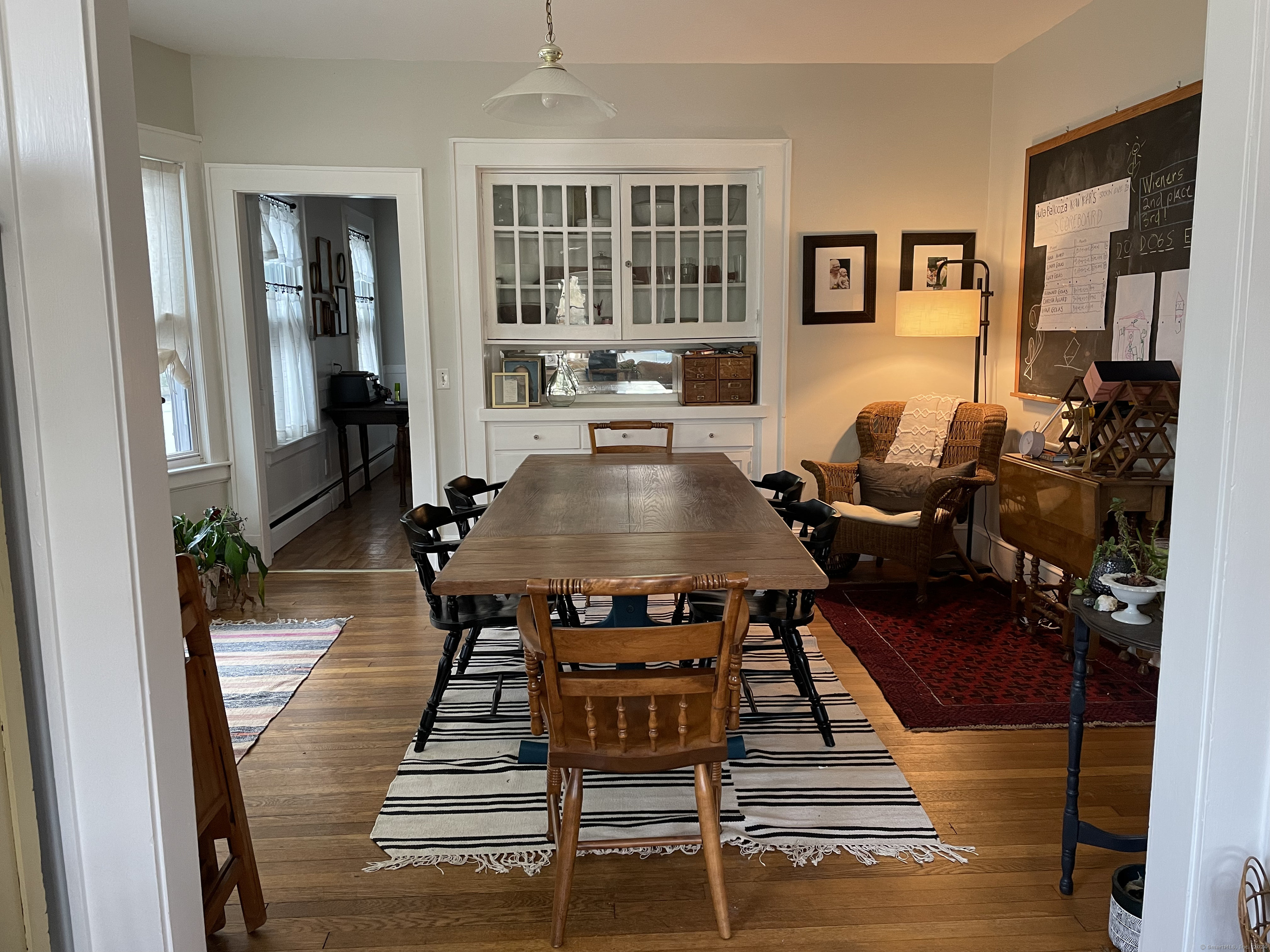 193-195 Wolcott Hill Road Wethersfield, CT 06109 - Photo 7 of 29 a living room with furniture a table and wooden floor