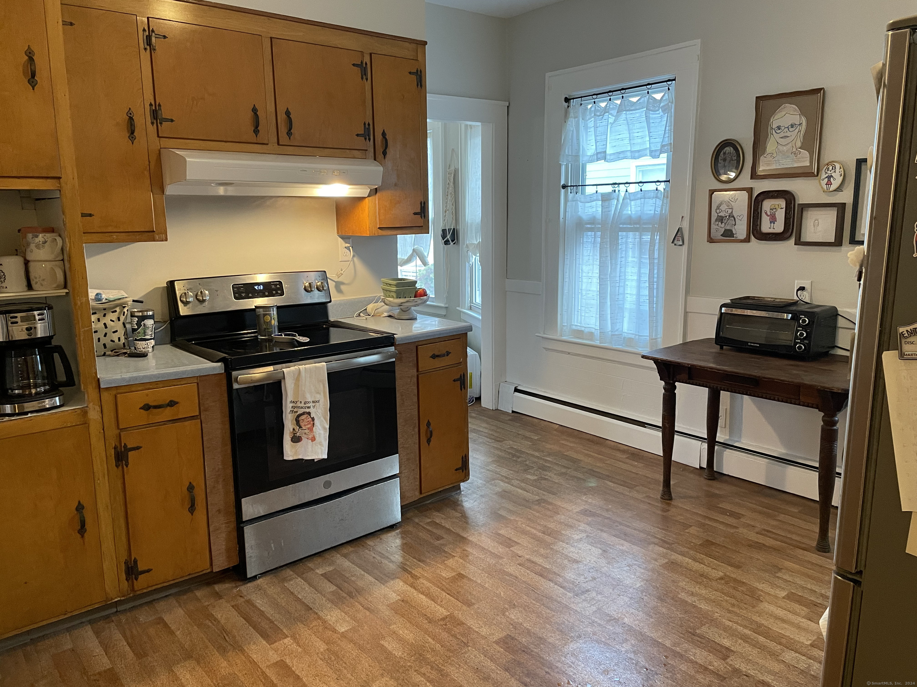 193-195 Wolcott Hill Road Wethersfield, CT 06109 - Photo 8 of 29 a kitchen with stainless steel appliances granite countertop a stove and a refrigerator