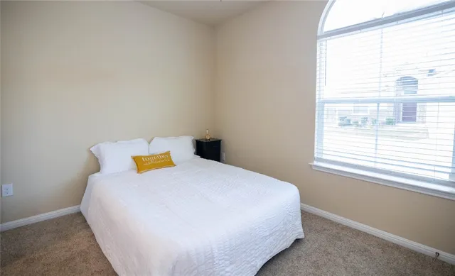 a view of walk in closet with clothes