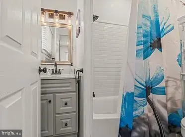 a bathroom with a sink a mirror and a shower