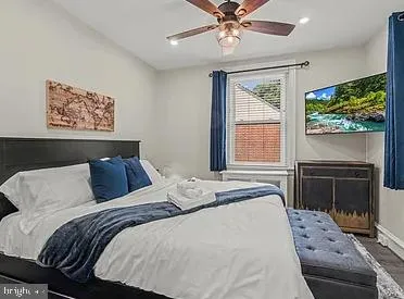 a bedroom with a large bed and a window