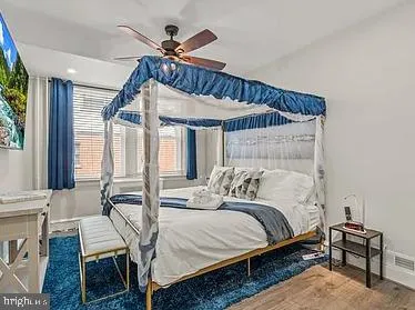 a bedroom with a bed a window and couch