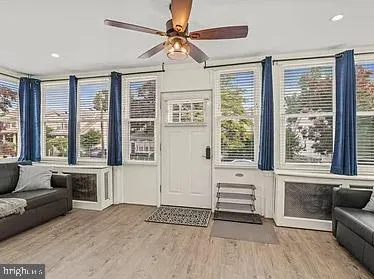 a living room with furniture and large windows