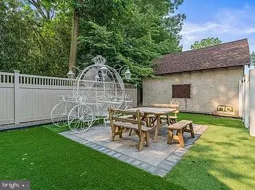 a view of a chair and table in backyard of the house