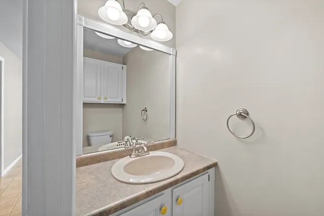 a bathroom with a sink vanity and a mirror