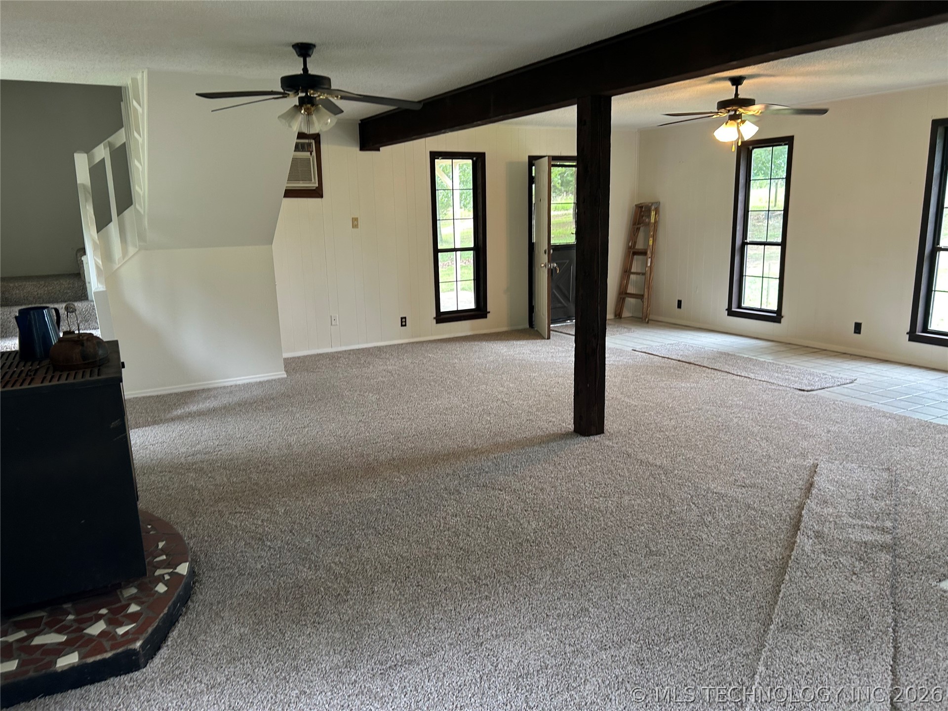 110955 East 1110 Road Sallisaw, OK 74955 - Photo 13 of 22 Spacious interior featuring light gray carpeting and white vertical paneling