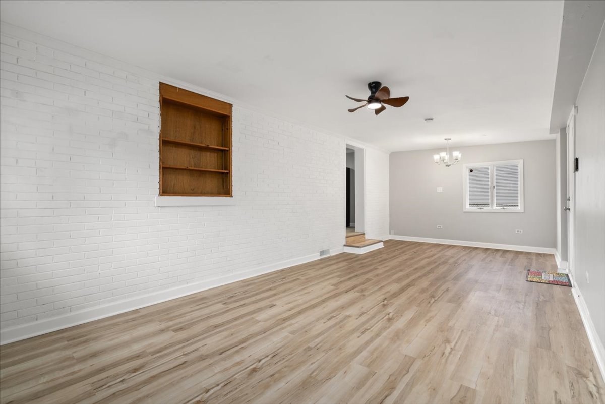3923 Madison Avenue Brookfield, IL 60513 - Photo 16 of 26 wooden floor in an empty room with a window