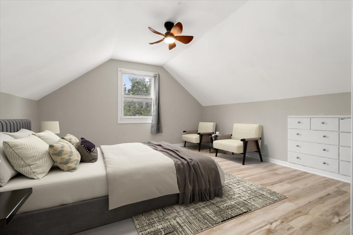 3923 Madison Avenue Brookfield, IL 60513 - Photo 17 of 26 a bedroom with a bed and a chandelier