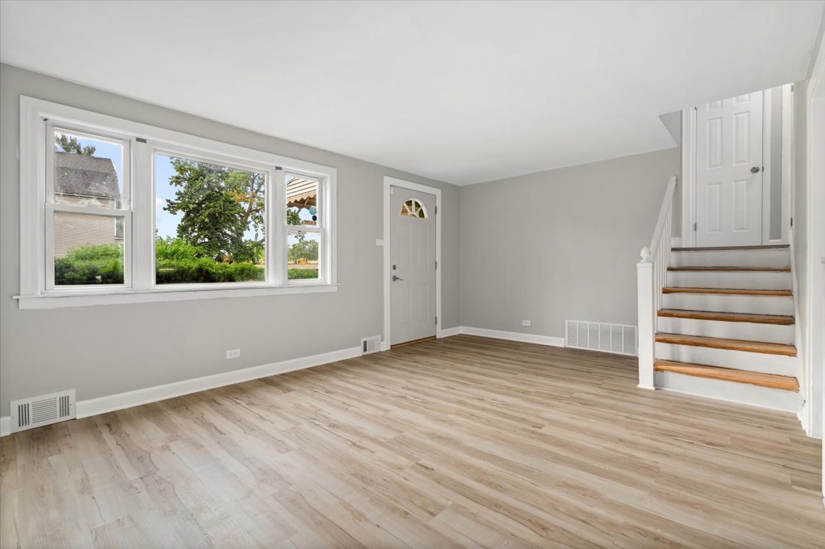 3923 Madison Avenue Brookfield, IL 60513 - Photo 6 of 26 wooden floor in an empty room with a window