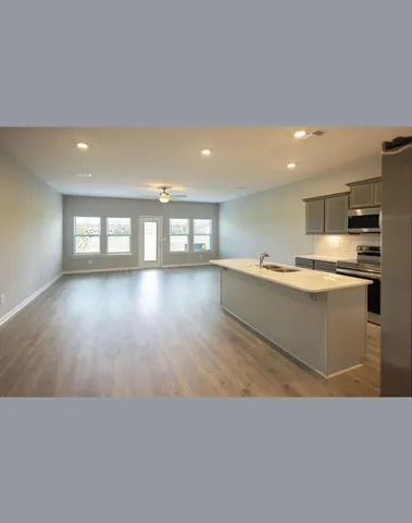 a kitchen with stainless steel appliances granite countertop a stove a sink and a refrigerator