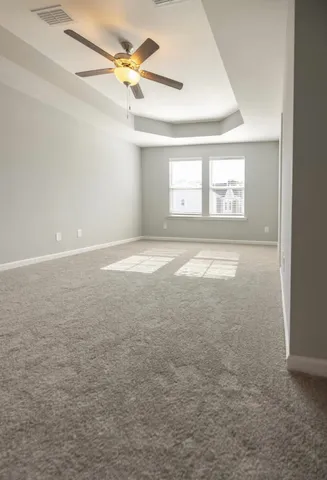 a view of an empty room with a ceiling fan