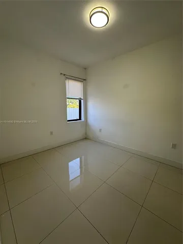 an empty room with windows and entrance