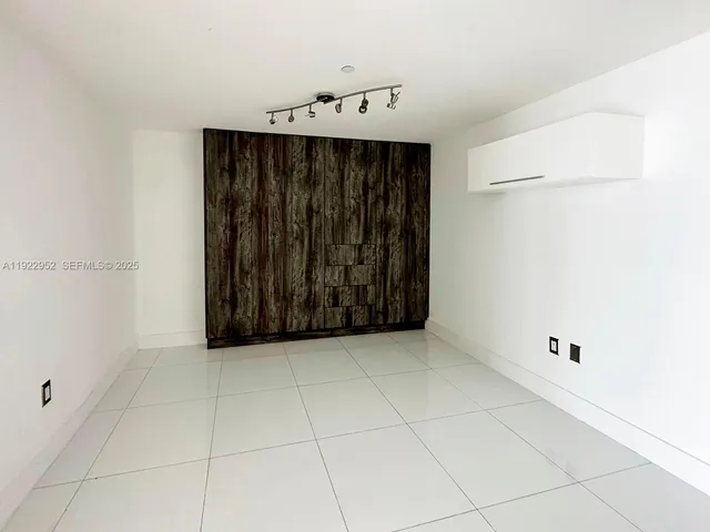 a view of a utility room with cabinets