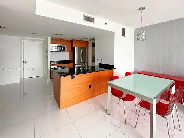 a room with pool table and windows