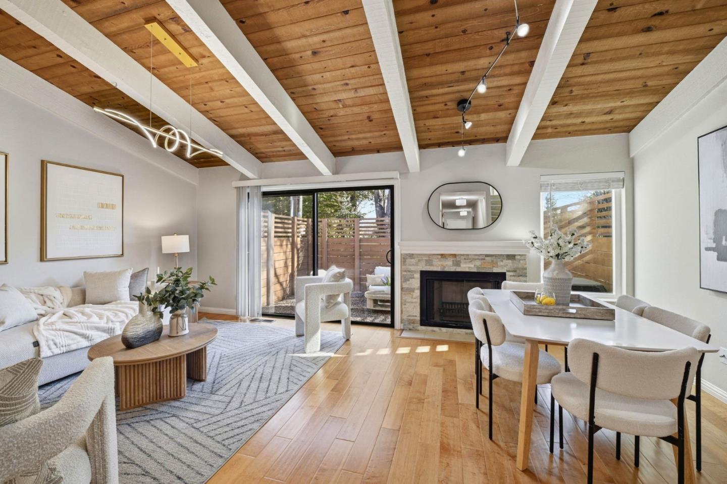 751 West Middlefield Road, Unit C Mountain View, CA 94043 - Photo 2 of 27 a living room with furniture a fireplace and a dining table with wooden floor