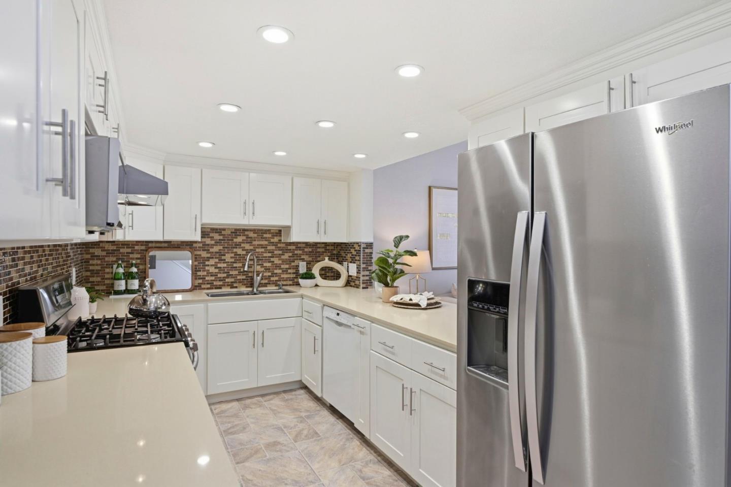751 West Middlefield Road, Unit C Mountain View, CA 94043 - Photo 8 of 27 a kitchen with white cabinets and stainless steel appliances