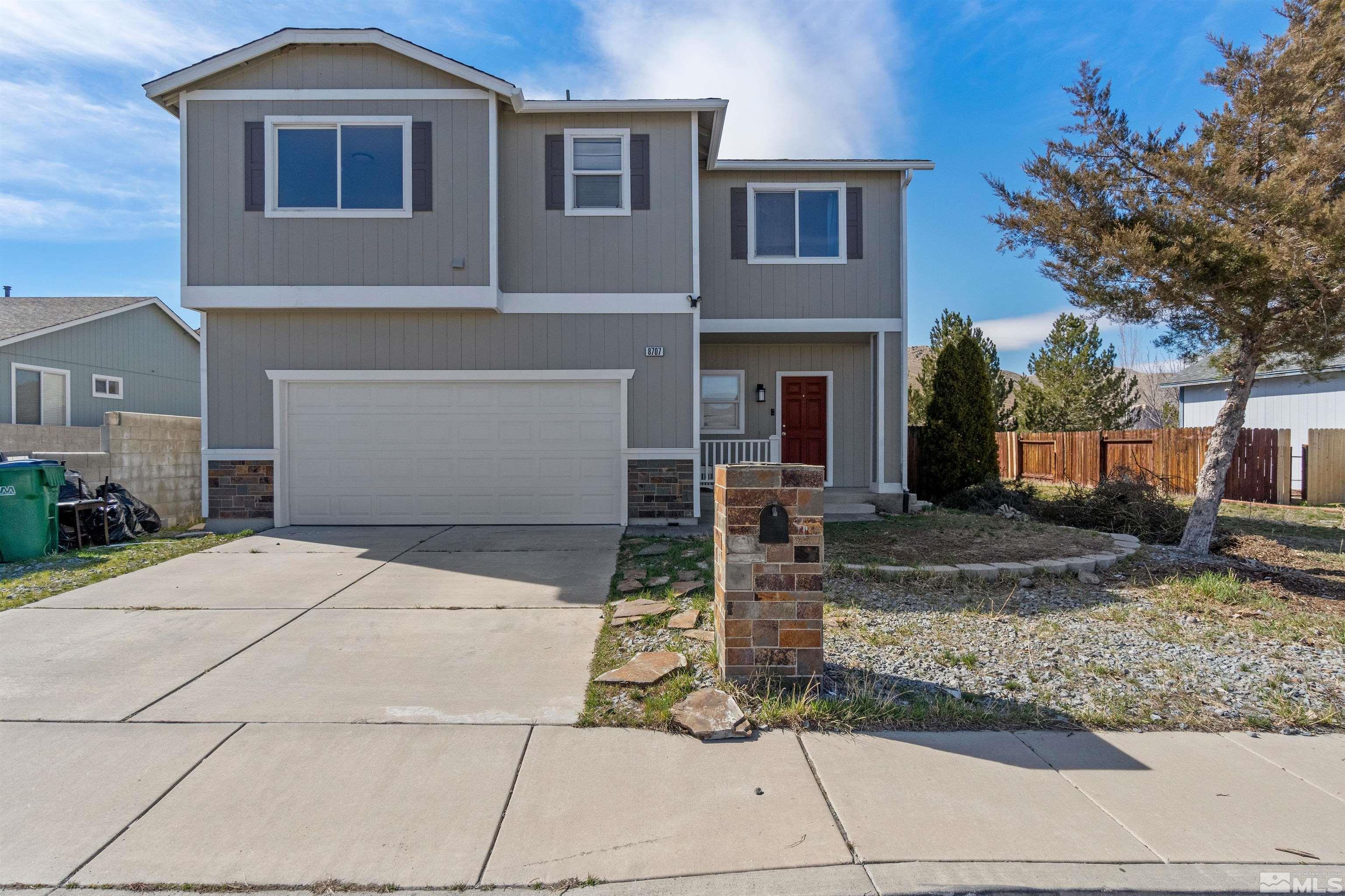 8707 Malibu Drive Reno, NV 89506 - Photo 1 of 35 a front view of a house with garden