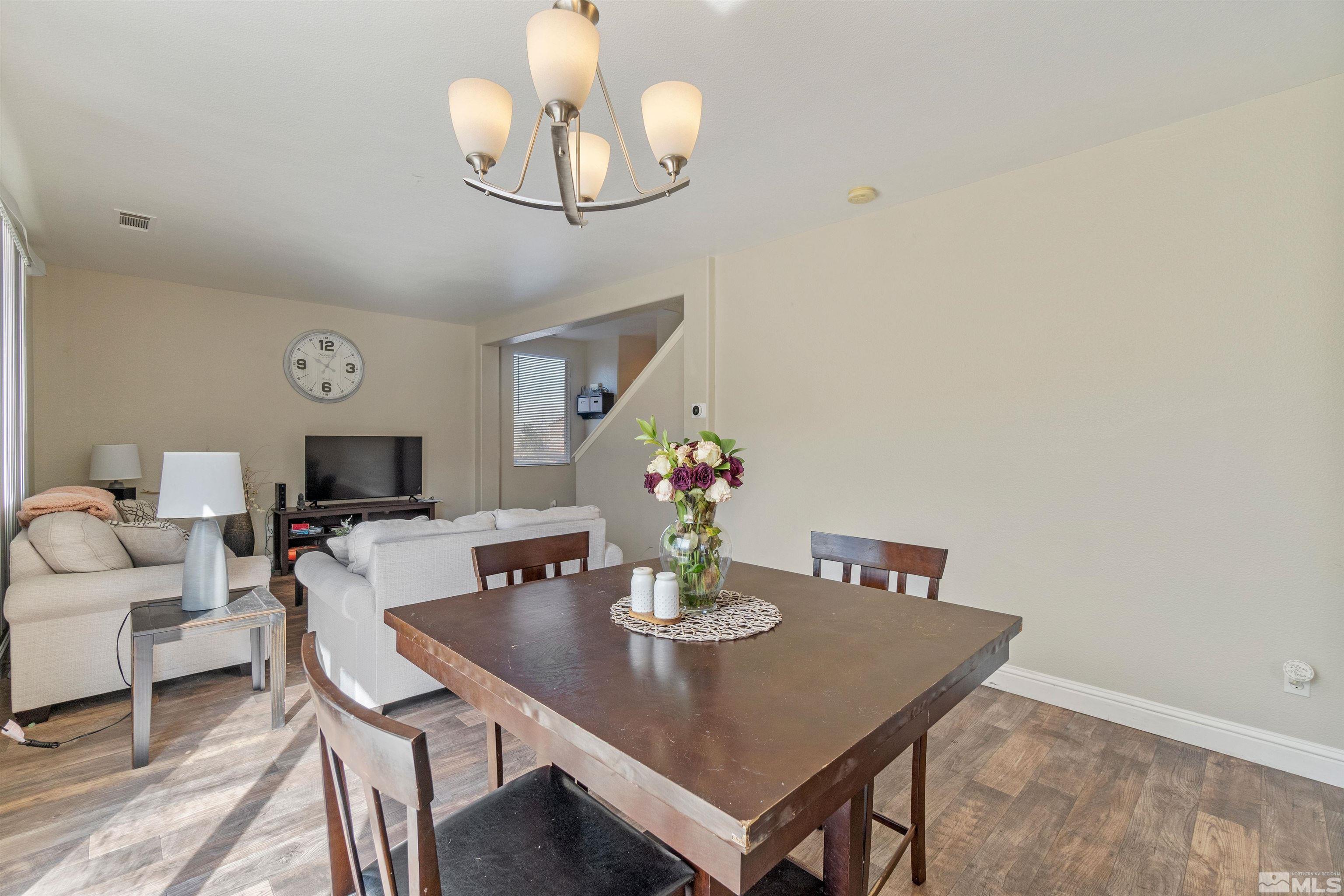 8707 Malibu Drive Reno, NV 89506 - Photo 11 of 35 a view of a dining room with furniture and wooden floor
