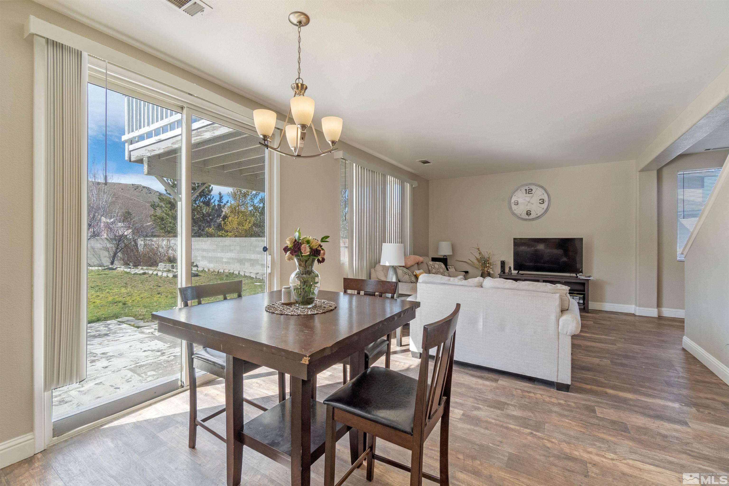 8707 Malibu Drive Reno, NV 89506 - Photo 12 of 35 a view of a dining room with furniture window and wooden floor