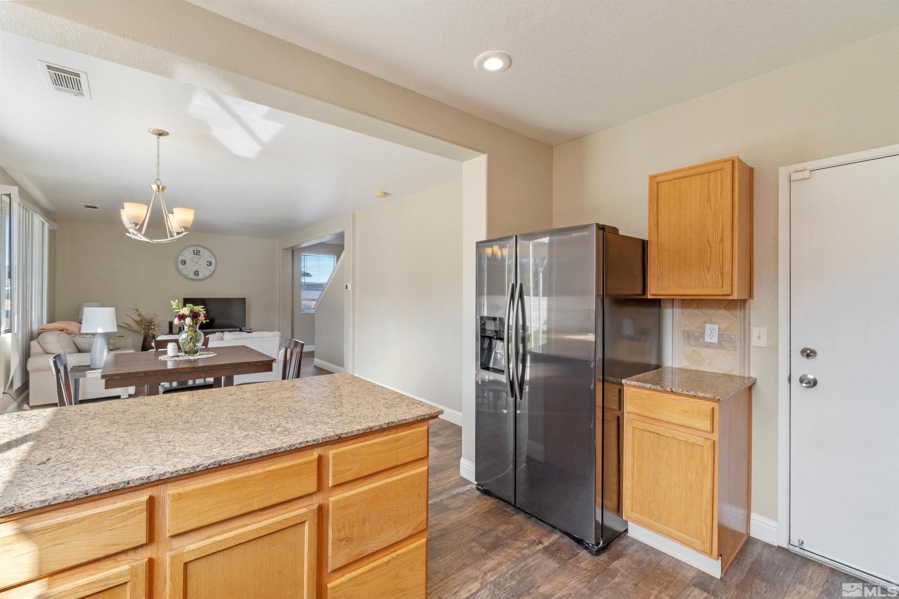 8707 Malibu Drive Reno, NV 89506 - Photo 15 of 35 a kitchen with stainless steel appliances granite countertop a refrigerator a sink and a stove