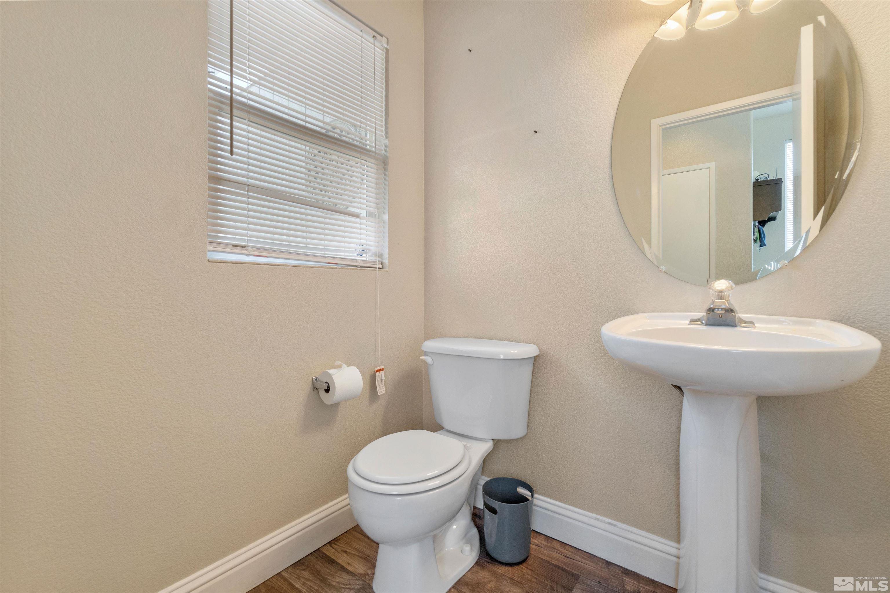 8707 Malibu Drive Reno, NV 89506 - Photo 18 of 35 a bathroom with a sink toilet and a mirror
