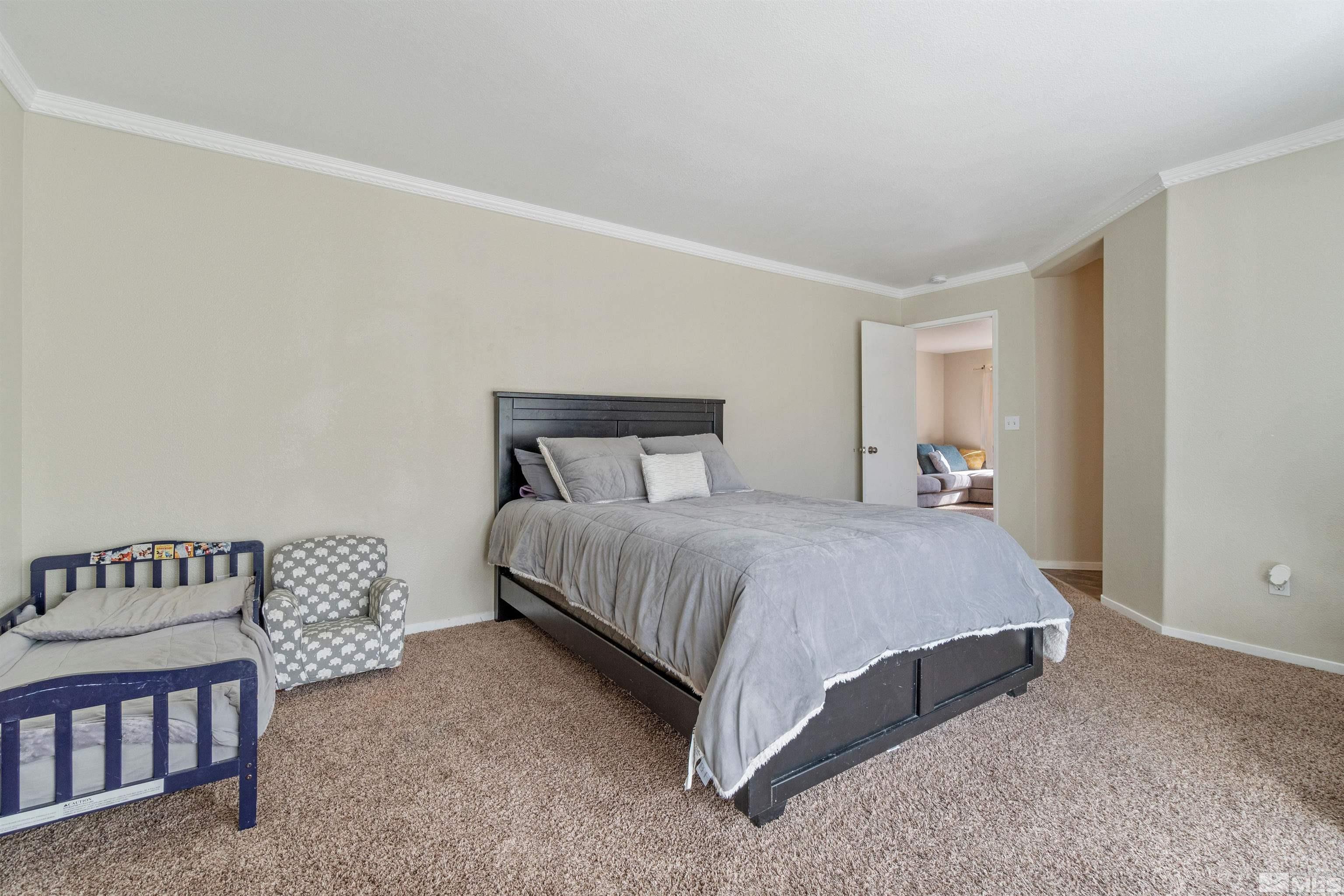 8707 Malibu Drive Reno, NV 89506 - Photo 24 of 35 a bedroom with a bed and window