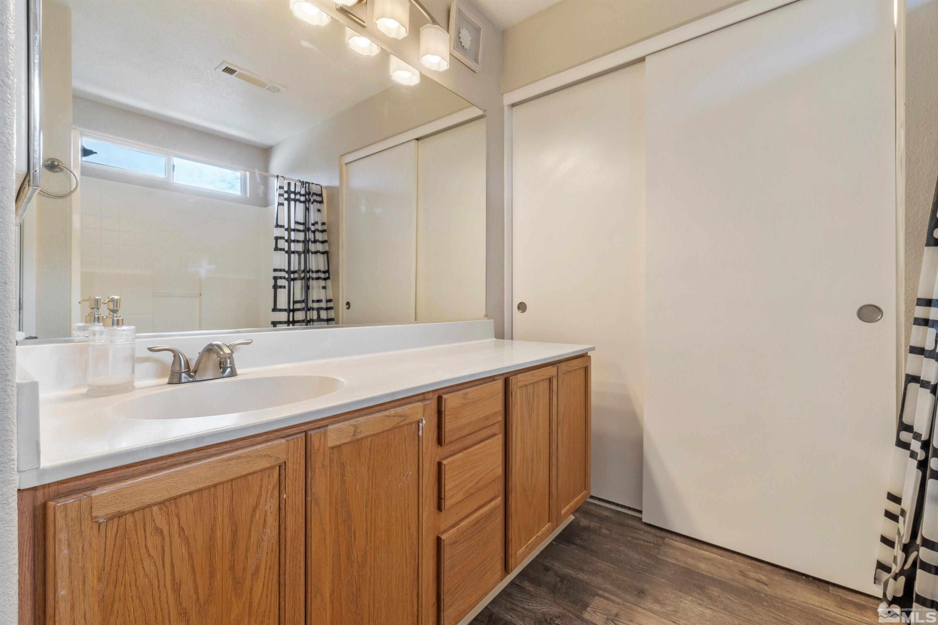 8707 Malibu Drive Reno, NV 89506 - Photo 25 of 35 a bathroom with a sink and a mirror