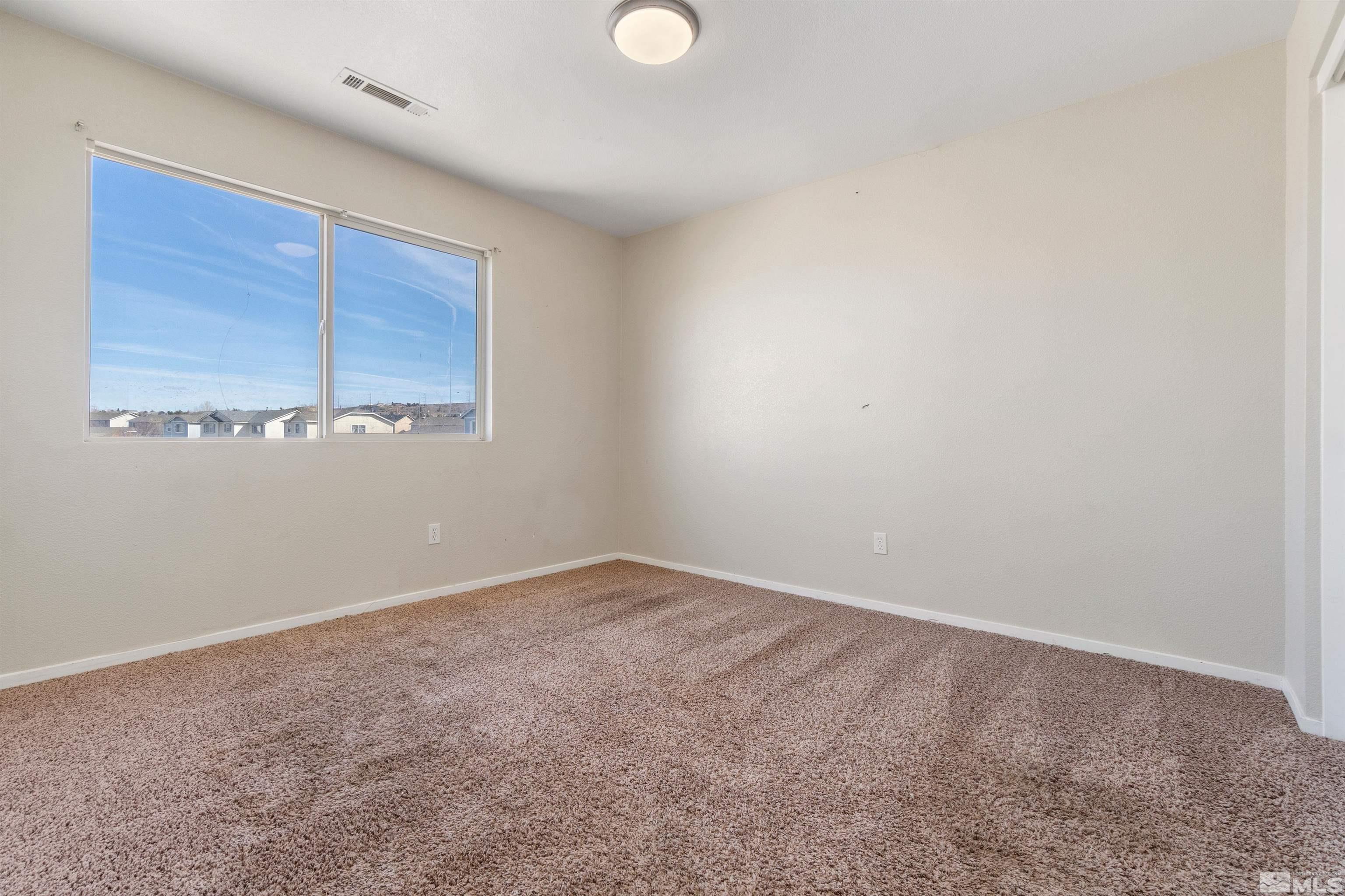 8707 Malibu Drive Reno, NV 89506 - Photo 27 of 35 a view of an empty room with window and cabinet