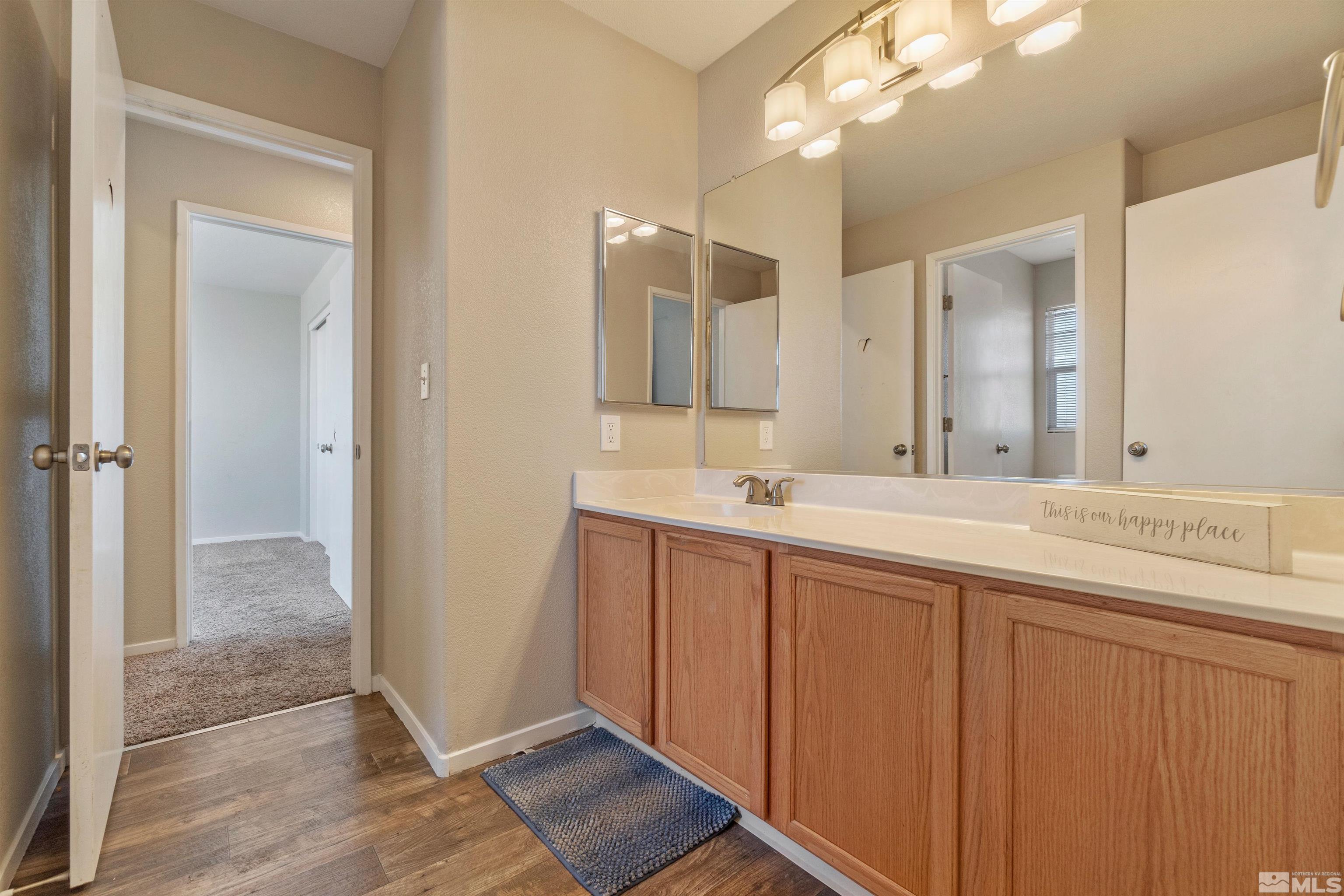8707 Malibu Drive Reno, NV 89506 - Photo 29 of 35 a bathroom with a double vanity sink and a mirror
