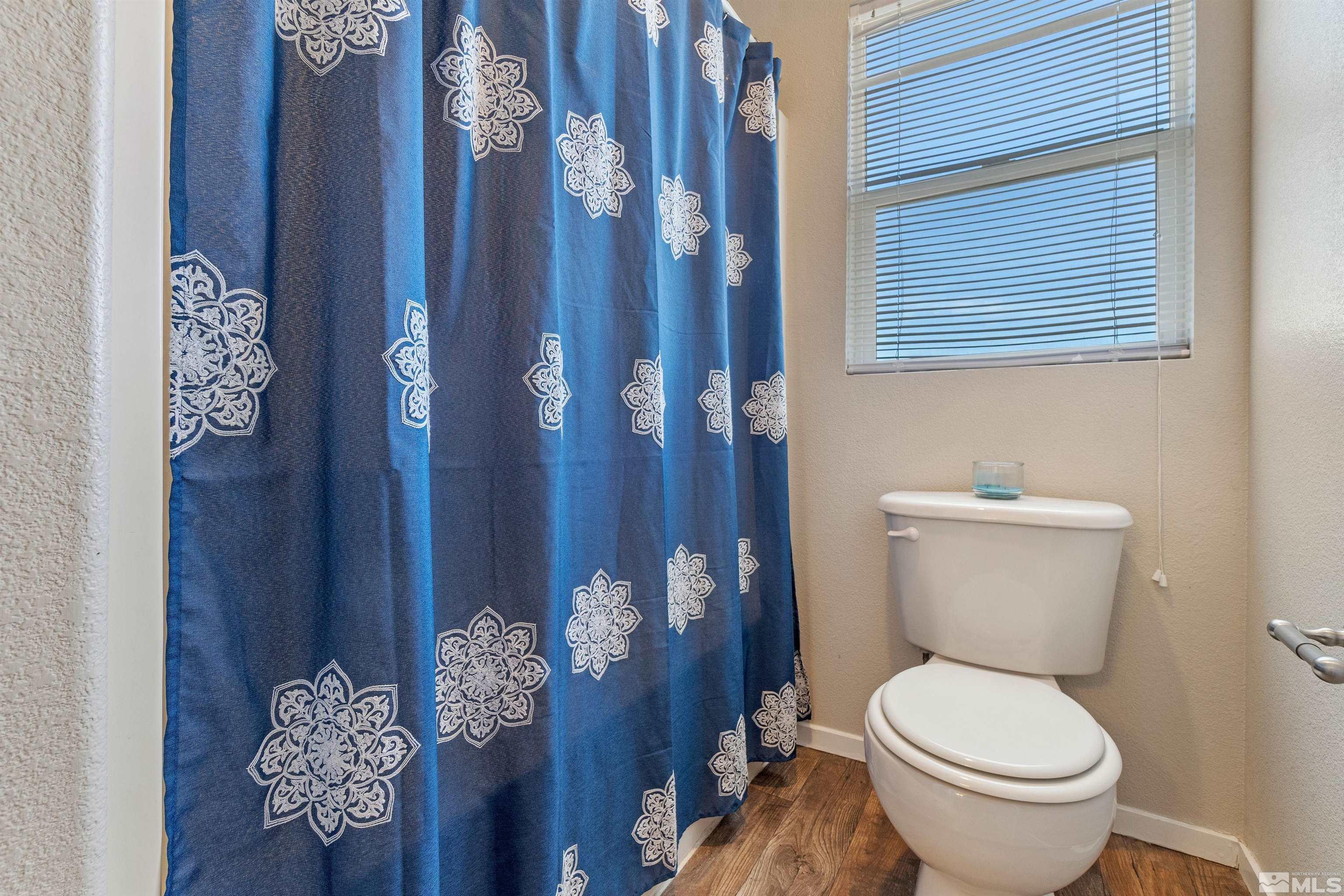 8707 Malibu Drive Reno, NV 89506 - Photo 30 of 35 a white toilet sitting next to a bathroom sink