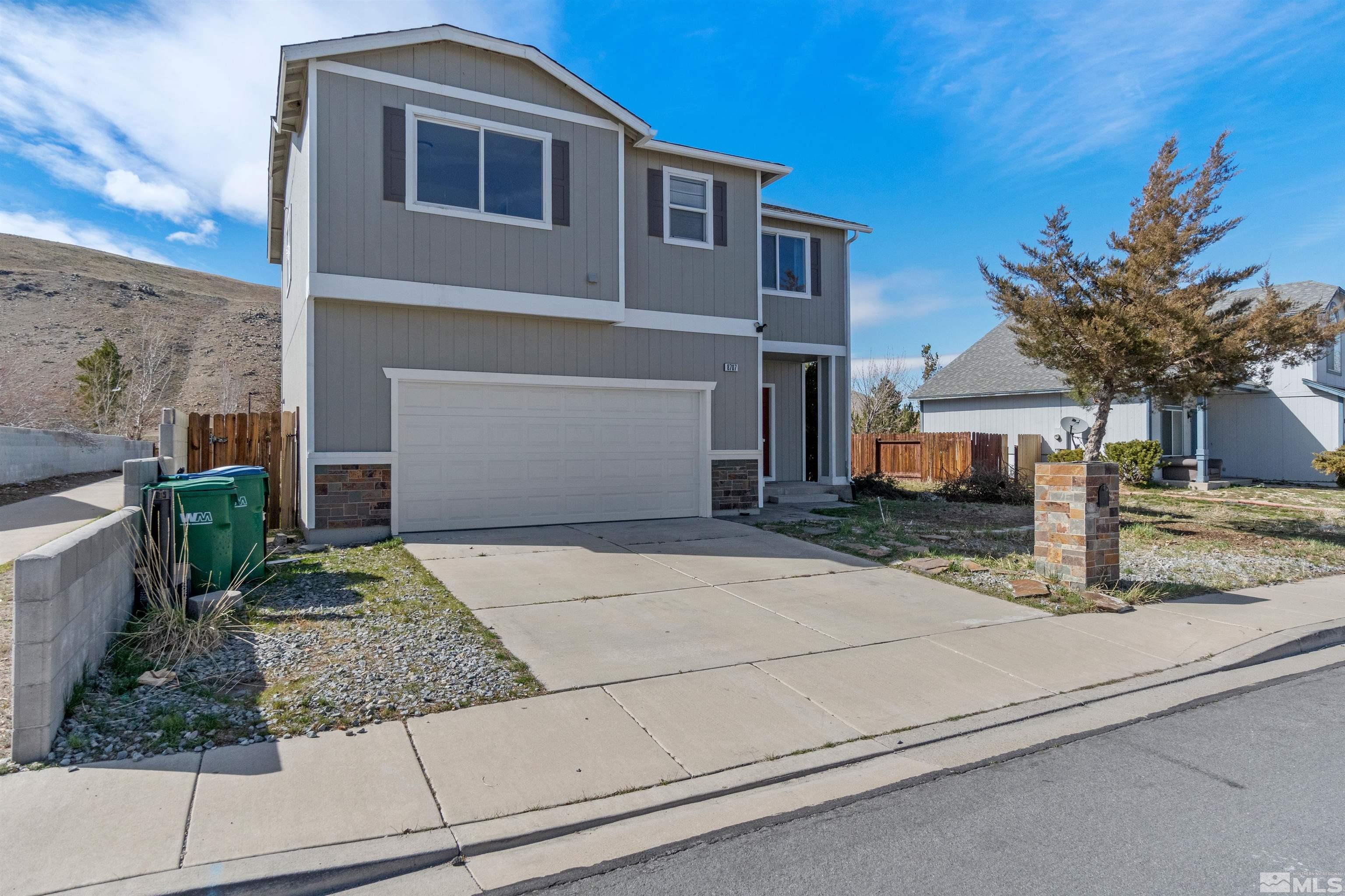8707 Malibu Drive Reno, NV 89506 - Photo 3 of 35 a front view of a house with garden