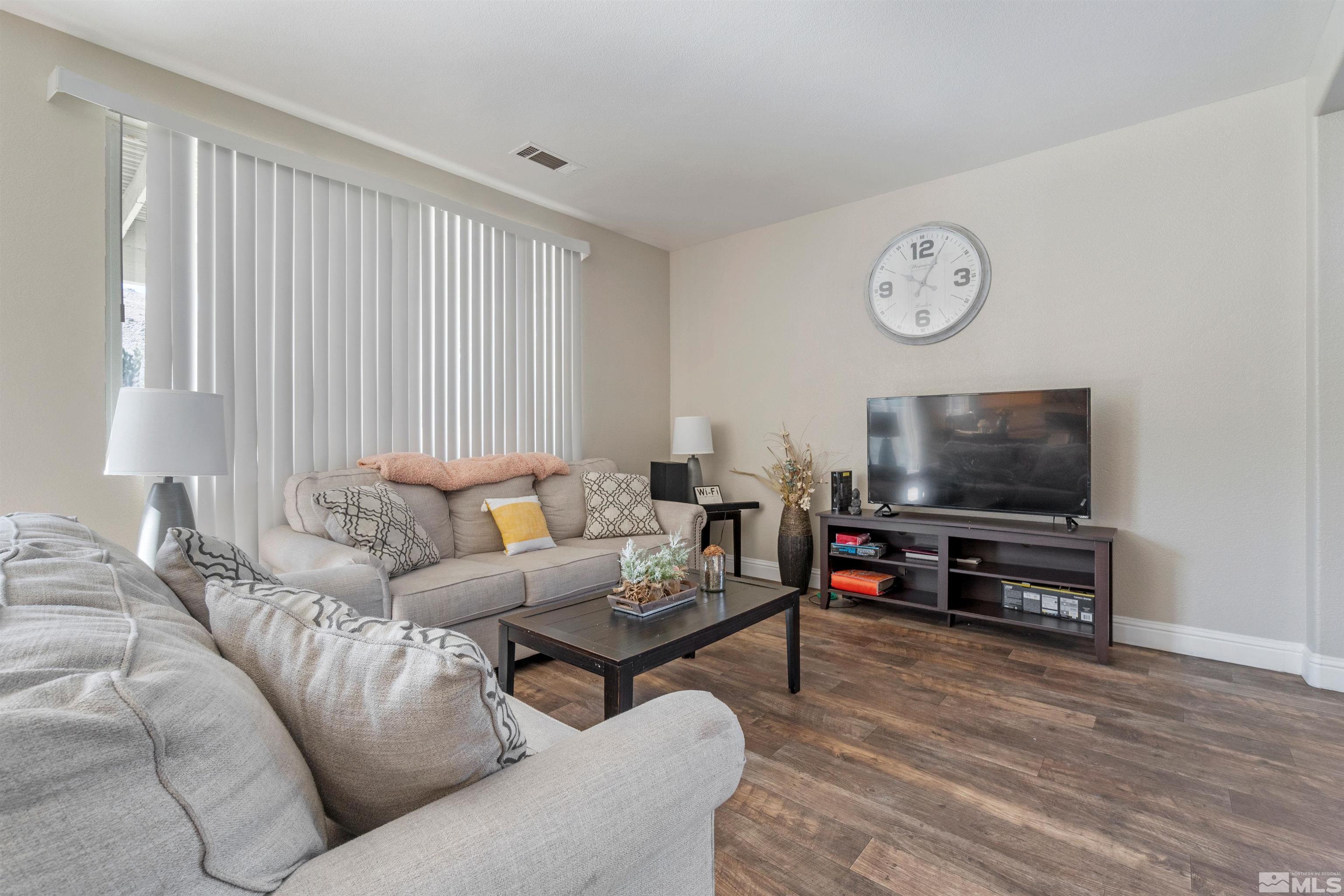 8707 Malibu Drive Reno, NV 89506 - Photo 6 of 35 a living room with furniture and a flat screen tv