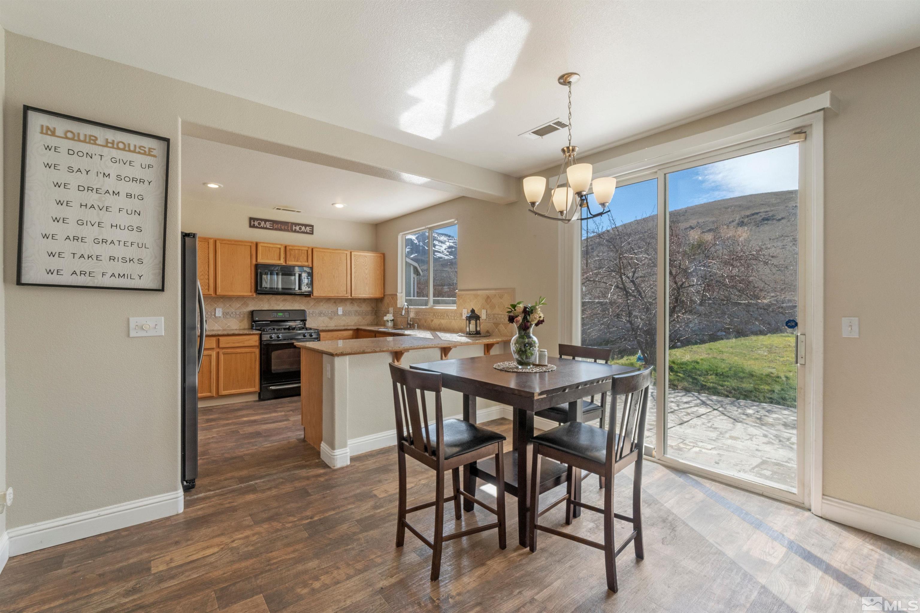 8707 Malibu Drive Reno, NV 89506 - Photo 9 of 35 a view of a dining room with furniture window and wooden floor