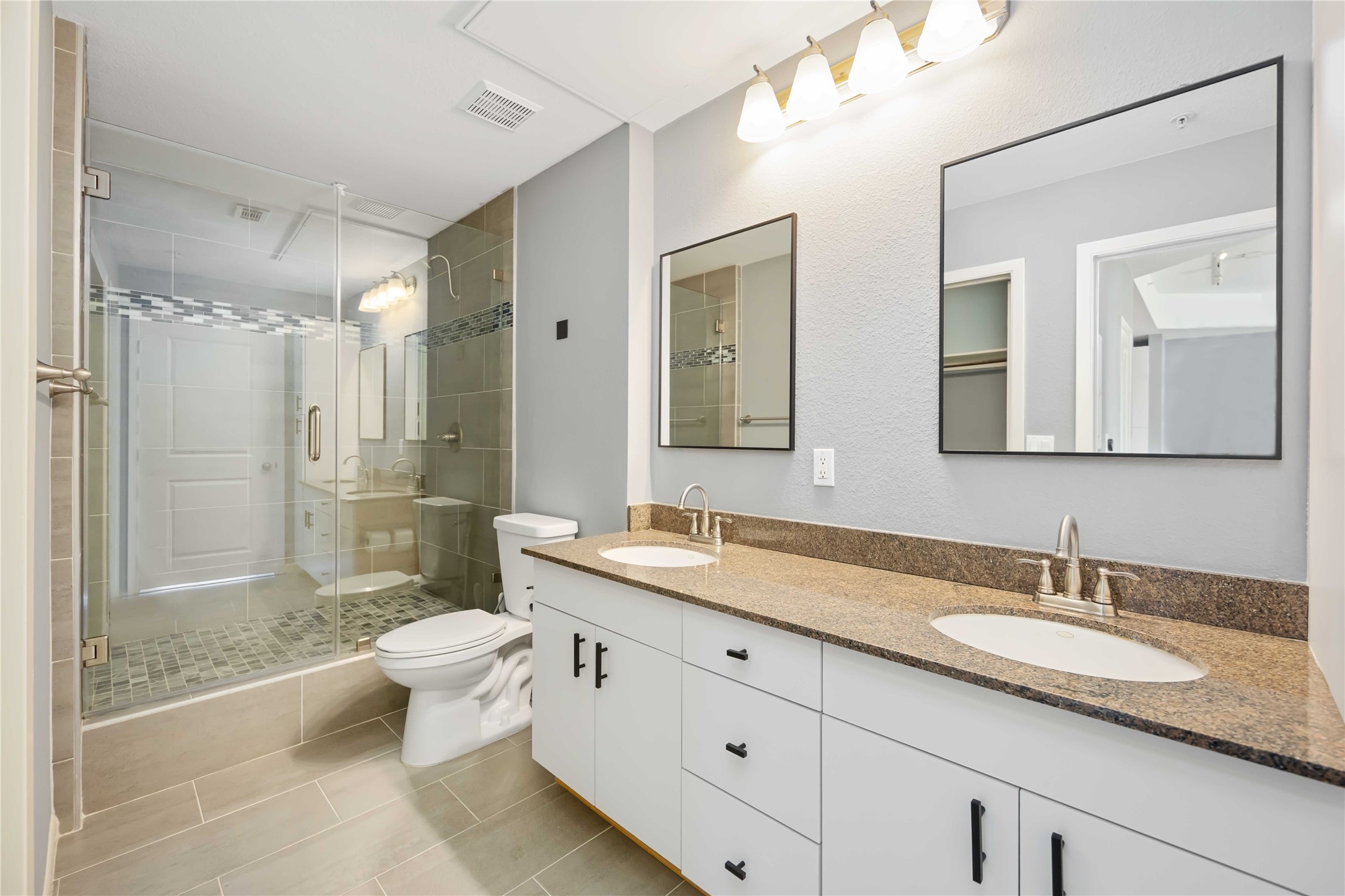3505 Sage Road, Unit 1508 Houston, TX 77056 - Photo 9 of 23 The primary bathroom features a completely updated layout with a modern walk-in shower, double sinks, granite counter space, and integrated tile flooring.
