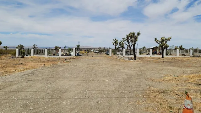 a view of a houses with snow on the road